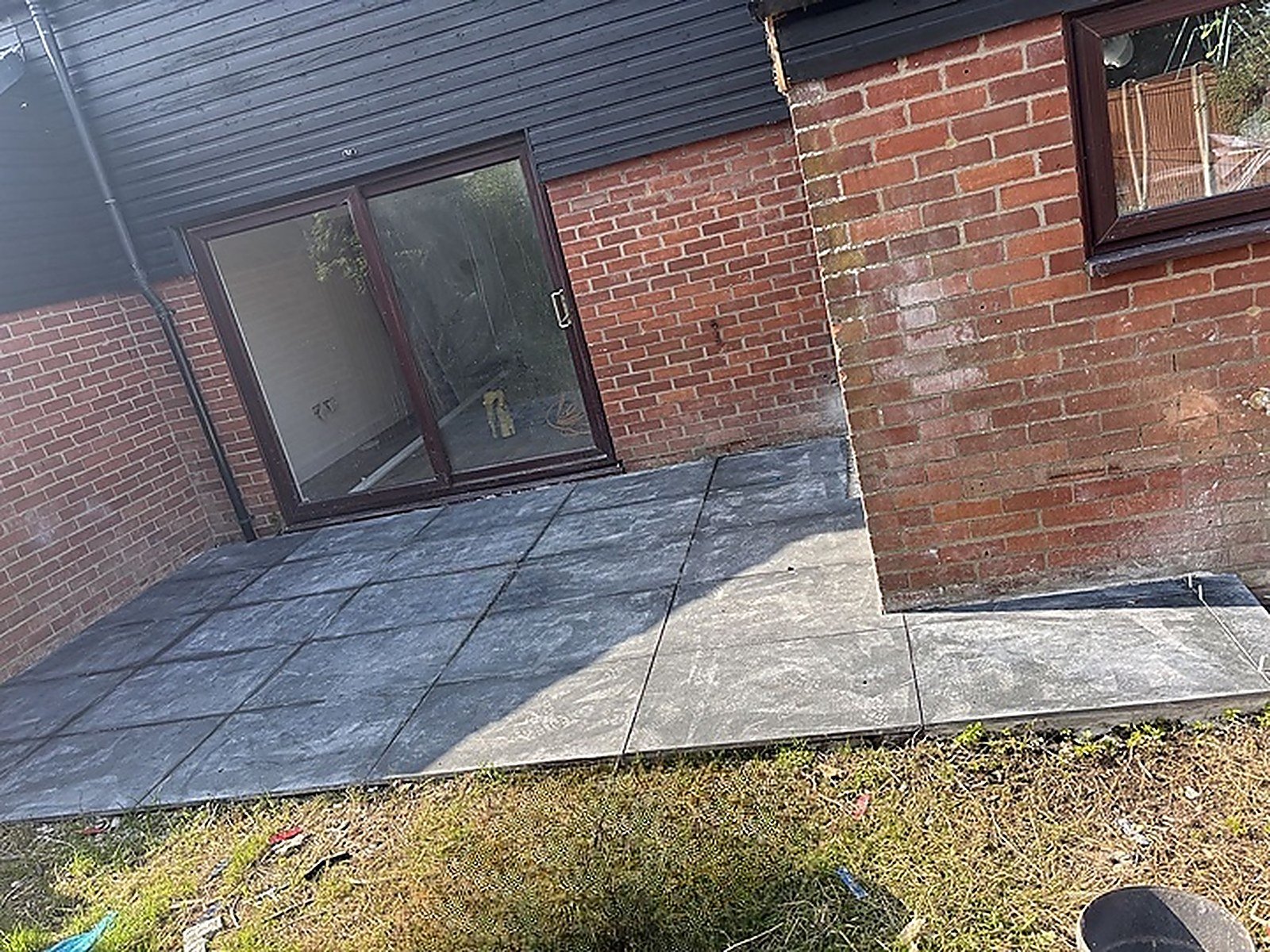 A new slate patio outside sliding doors