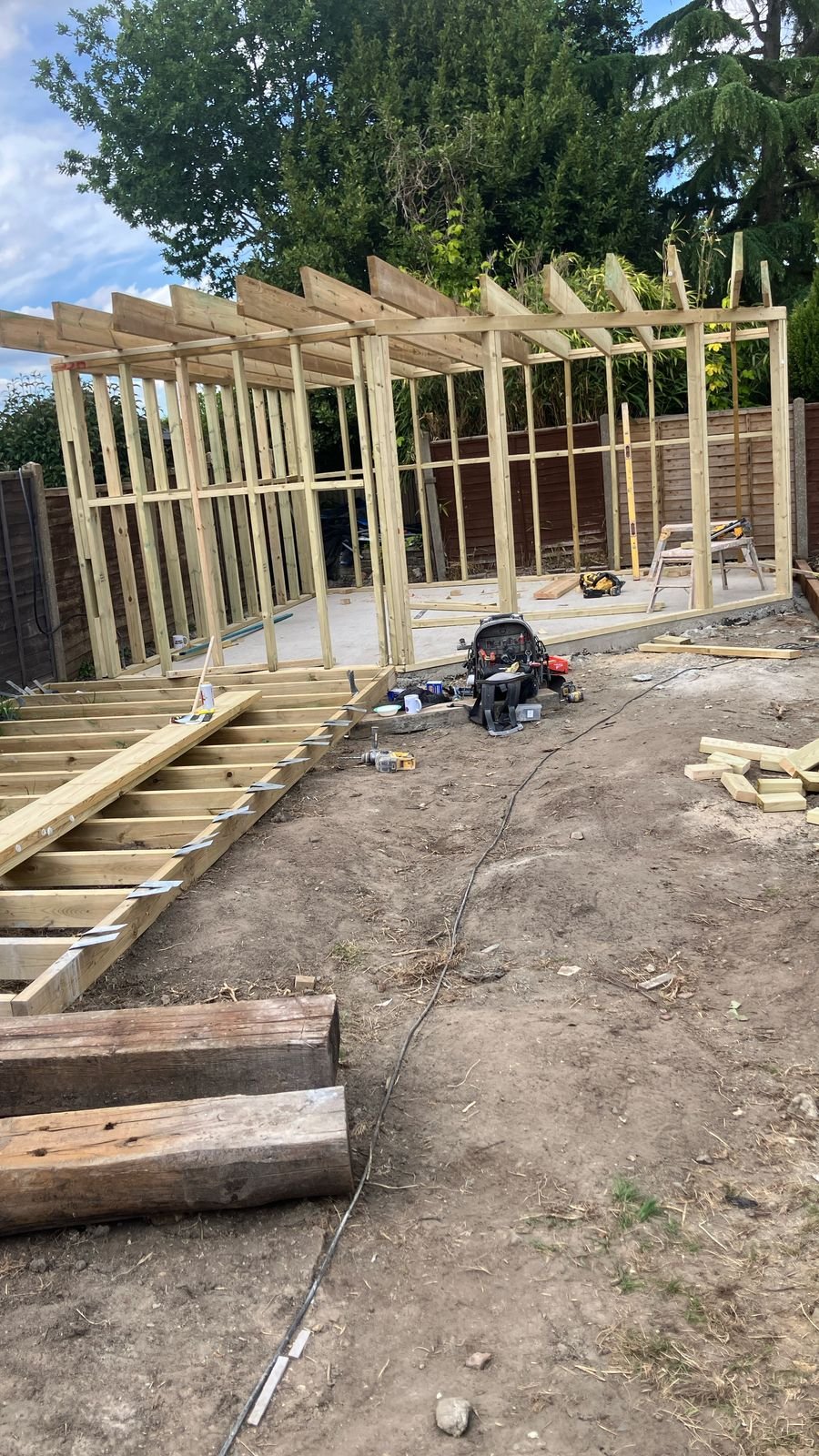 A timber frame going up for a garden room