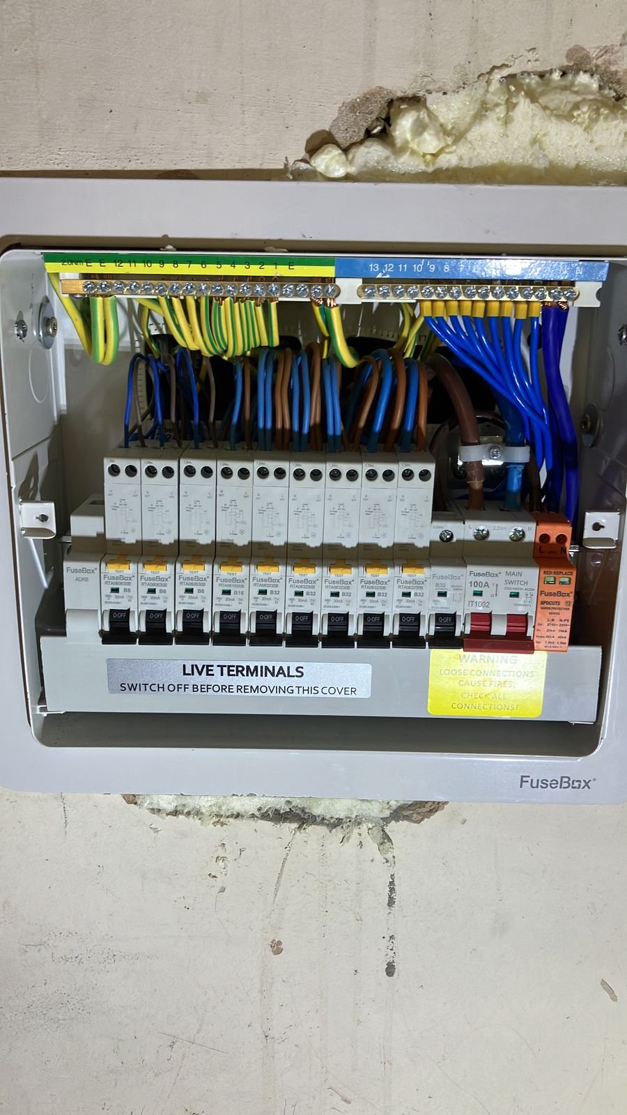 A consumer unit with RCBOs and surge protection, cover off